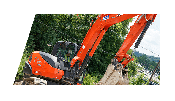 A Ken Neyer Plumbing working operating an excavation machine.