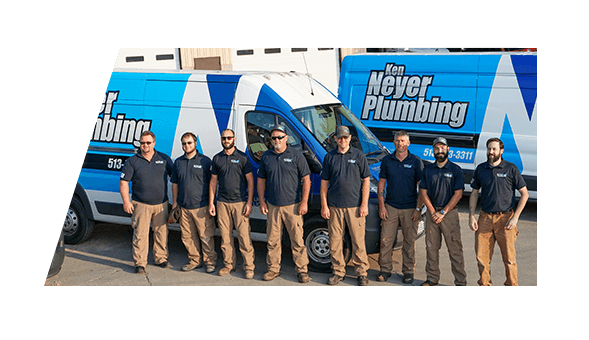 The Ken Neyer Plumbing Team standing in front of their trucks.