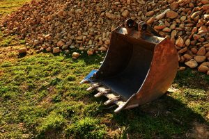 Backhoe-bucket-with-pile-of-rocks